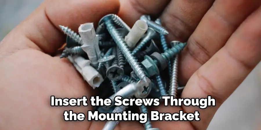 Insert the Screws Through the Mounting Bracket