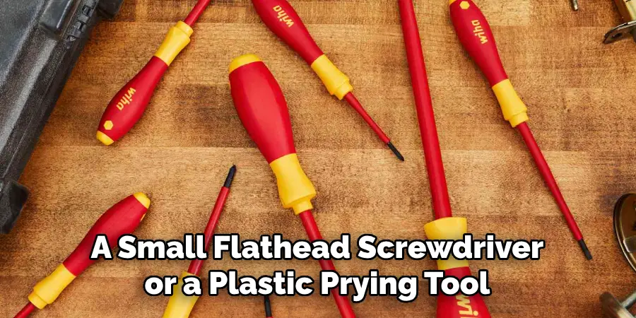 A Small Flathead Screwdriver or a Plastic Prying Tool