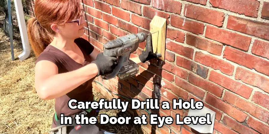 Carefully Drill a Hole in the Door at Eye Level